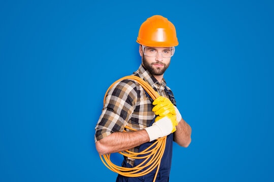 Portrait Of Trendy Virile Electrician In Hardhat, Overall, Shirt Is Ready For Work, Having, Holding Rolled Cable On Shoulder, Looking At Camera, Isolated On Grey Background