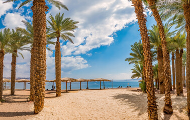 Morning on renovated sandy beach of the Red Sea in Eilat - famous tourist resort and recreational city in Israel. Concept of bliss vacation and happy holiday  