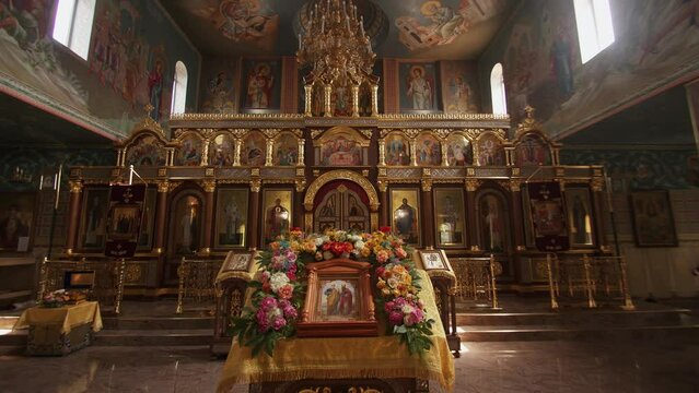 Magnificent interior of orthodox church with iconostasis and murals with saints on vault of dome. Slow motion