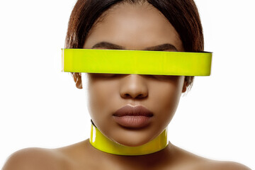 Beautiful black woman. Wearing high tech goggles. Stylish model in a neon accessory.