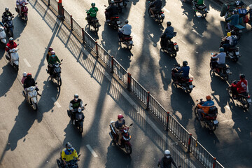 Road with motorcycle traffic looking down from high angle in beautiful late afternoon light with...