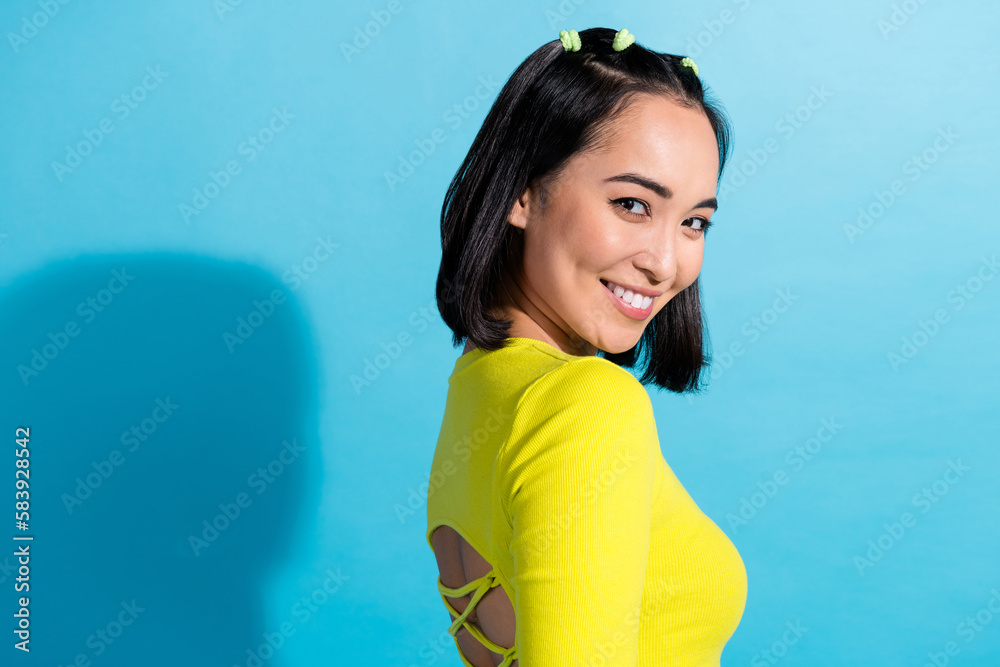 Sticker Side profile photo of young smiling chic attractive girlfriend wear yellow trendy crop top open back modern outfit isolated on blue color background