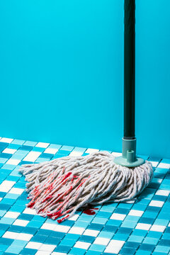 Mopping stick on floor with blood stains