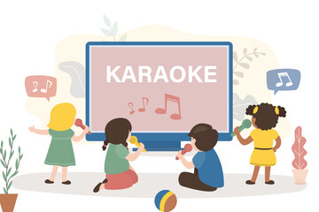 Kids watching on screen and sing songs. Group of kids uses microphones and sing karaoke. Multiethnic kids - musician and vocalist. Talent children, karaoke party.