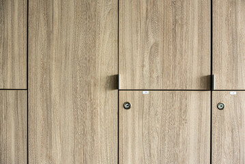 Wooden lockers with key in locker room at school sport club office.