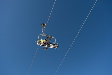 Vertical shot of  cableway cabin with two skiers