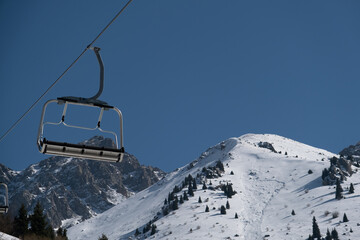 Empty cableway cabin under mountains