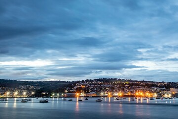 Long exposure shot of the townscape of Teignmouth at dusk captured from Shaldon beach