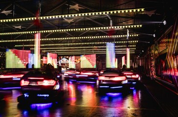 Long exposure shot of glowing bumper cars ride at the annual street fair in St Giles, Oxford