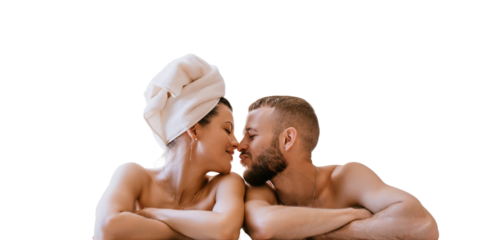 Young woman with wrapped towel around head naked encloses to husband at bath against transparent background. Happy couple enjoying honeymoon. Spa, bath, pool. Jacuzzi. Newlyweds on vacation
