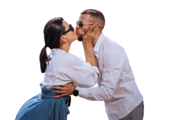 Young caucasian couple in casual clothes, sunglasses kissing against transparent background. Brunette American girl kisses beardy guy, romance concept, mockup. Travel, vacation, summertime.