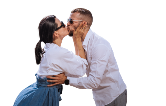 Young caucasian couple in casual  clothes, sunglasses kissing against transparent background. Brunette American girl kisses beardy guy, romance concept, mockup. Travel, vacation, summertime.