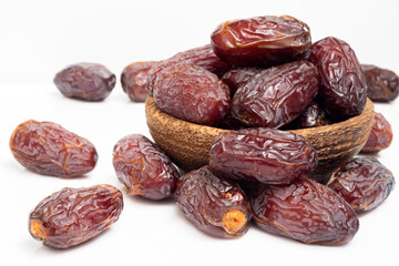 Fototapeta na wymiar pile of delicious dates isolated on white background. middle eastern food