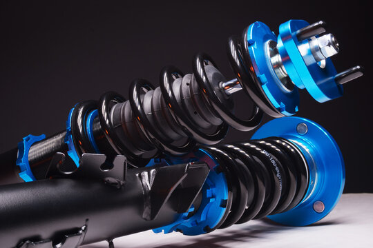 auto suspension tuning coilovers shock absorbers and springs blue for a sports drift car on a dark background