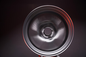 sporty metallic gray car rims extended illuminated by red light long exposure photography for motion blur effect when rotating