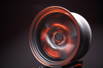 sporty metallic gray car rims extended illuminated by red light long exposure photography for...