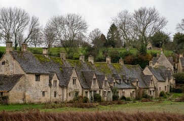Fototapeta na wymiar Row of the historic quintessential Cotswold cottages in Bibury, Gloucestershire, England