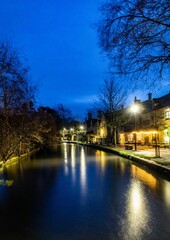 Long exposure of river through Bourton on the Water in The Cotswolds in winter. in the evening
