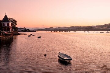 Naklejka premium Aerial view of small empty boats in the Teign river estuary at Shaldon, Devon at dusk