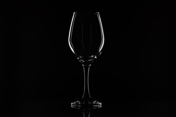 Wine glass on the black background. White contour on the black. 