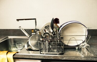 Closeup of drying kitchen utensils on a counter