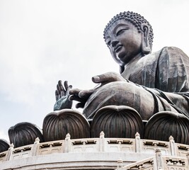 Low angle shot of large bronze Tian Tan Buddha monument in Hong Kong