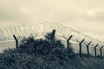 Razor wire topped perimeter fencing at an abandonned military base