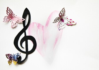 Colorful paper cut out butterflies with a musical treble cleff and a handrawn pink heart