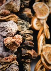 Closeup of dried mushrooms and lemons on black background