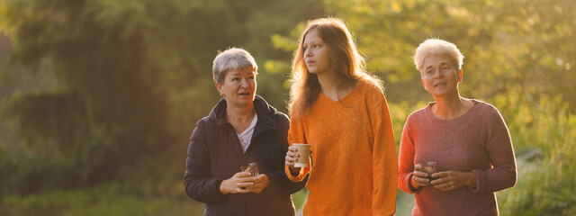 family of senior woman and teenager talking about activity recreation and picnic while coffee breakfast together in morning weekend, camping travel vacations trip in holiday, outdoor leisure party