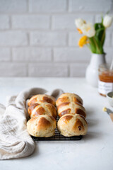 Easter breakfast with traditional hot cross bun and apricot jam. 