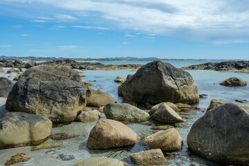 Fototapeta na wymiar Beautiful view of big rocks on the coastline under the peaceful sky