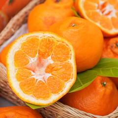 Fresh juicy clementine in wooden box. whole or half cut