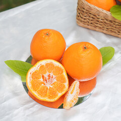 A set of oranges put together on a white table.
