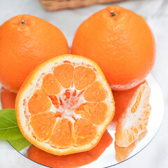 A set of oranges put together on a white table.