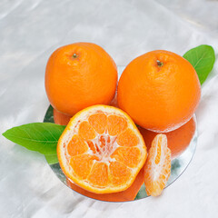 A set of oranges put together on a white table.