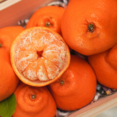 Ripe juicy orange tangerine whole in peel and slices isolated on white background with copy space, flat lay clipping path