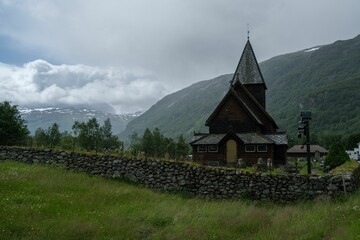 Beautiful shot of the historic Roldal Stave church near the mountains in Norway