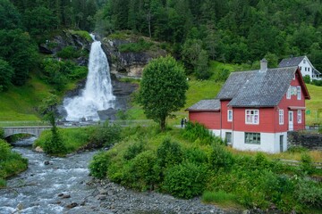 Fototapeta na wymiar Beautiful shot of the flowing Steindalsfossen waterfall in the mountains of Norway