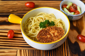Pasta with meat cutlet served as children's menu close up