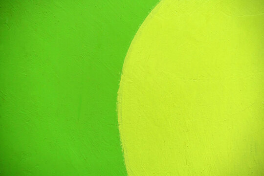 Green and yellow painted texture for background. Art concept with two colors painted side by side. The walls are decorated with the use of green and yellow.
