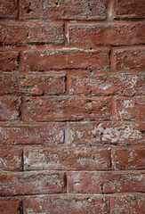 Old red painted brick wall close