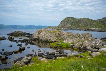 Fototapeta na wymiar Beautiful view of rock formations at the coastline in Refviksanden Beach