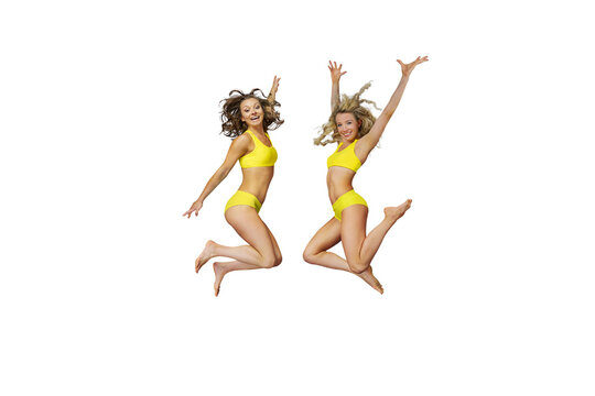 Two young girls enthusiastically jumps up and smiles at free isolated PNG background. beach, vacation concept.