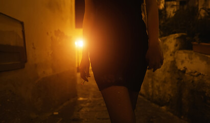 Female prostitute with cigarette on the street. - obrazy, fototapety, plakaty