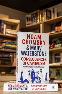 Close up Noam Chomsky and Marv Waterstone's Consequences of Capitalism book in the bookshop.