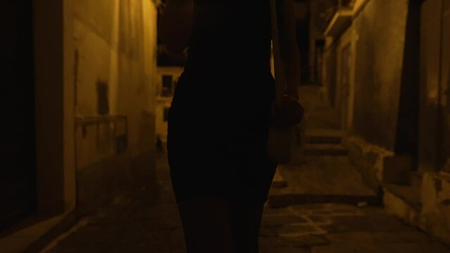Prostitute with cigarette walking on the street.