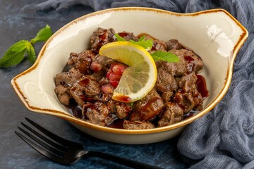Closeup shot of chicken leaver served with sauce and lemon, hot appetizer