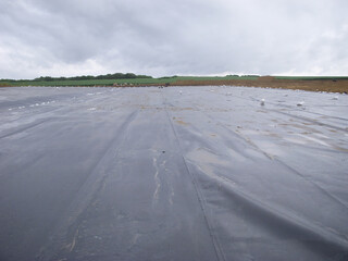 Landfill expansion project with unrolled HDPE synthetic liner.