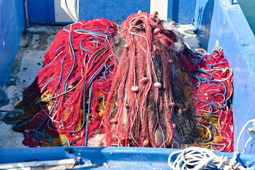 Fishing nets tangled on an old boat in the dock